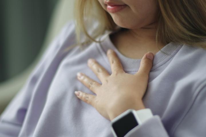 patient clutching chest