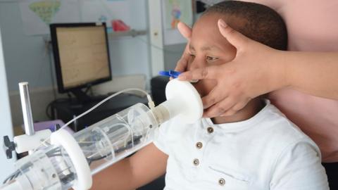 Child using a breathing device